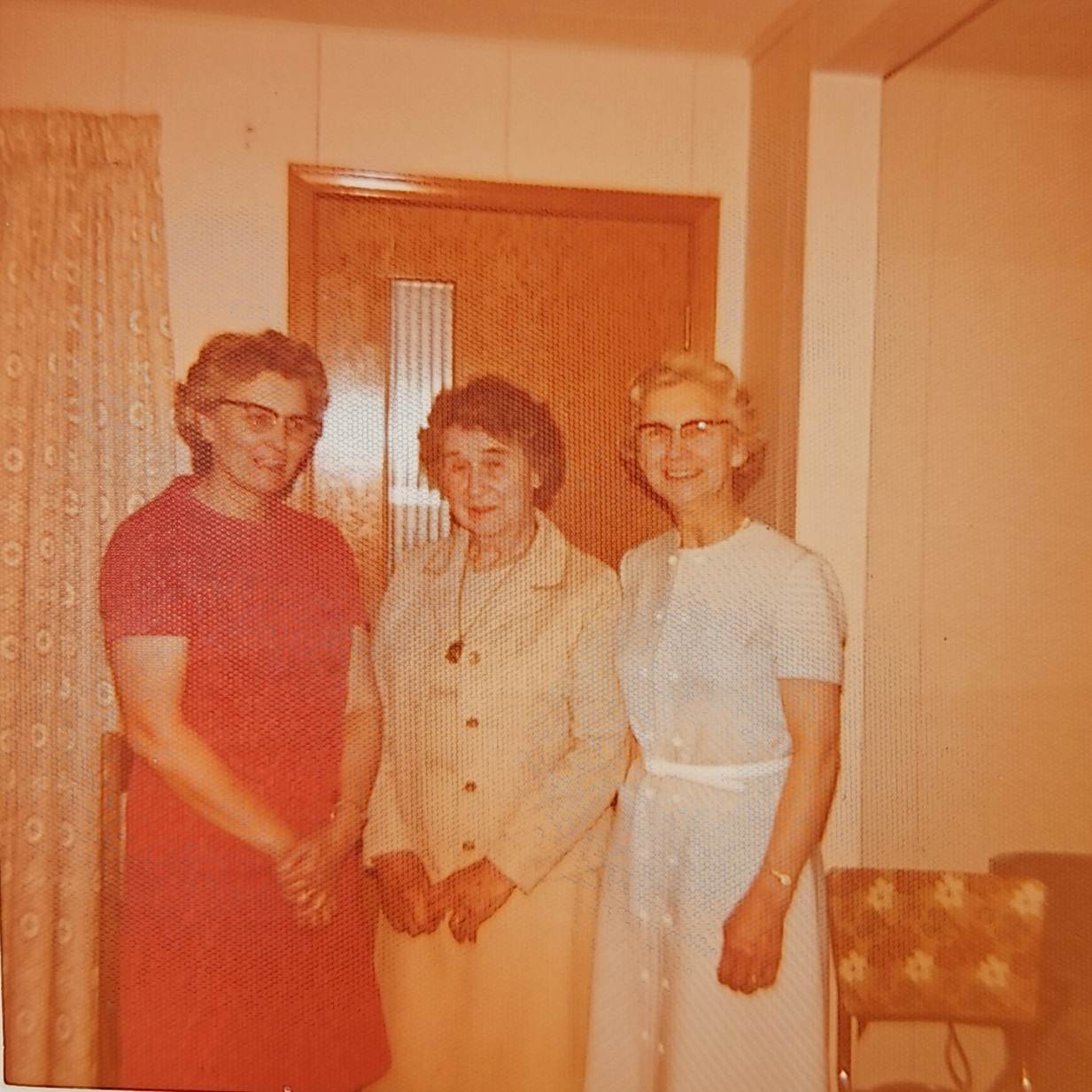 A group of women standing in a room

Description automatically generated